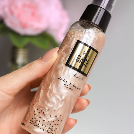 La PIEL Glow Babe Pink Bronze Shimmering Body Mist Hand Holding Bottle